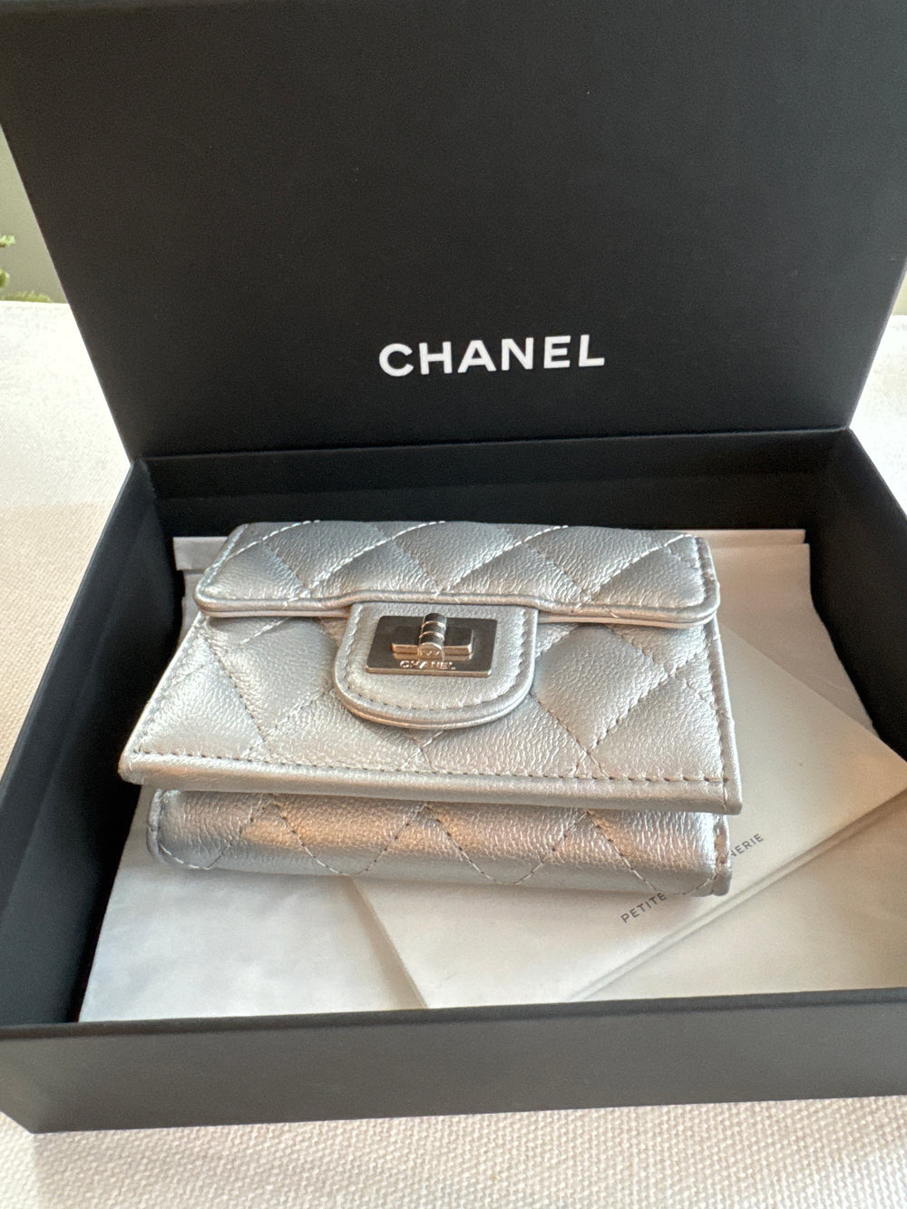 Chanel Matelasse small flap trifold wallet in silver . Boy turn lock