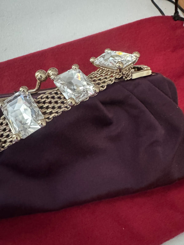 VALENTINO GARAVANI
Dark purple satin kiss logo clutch with embellished strap