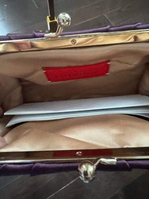 VALENTINO GARAVANI
Dark purple satin kiss logo clutch with embellished strap